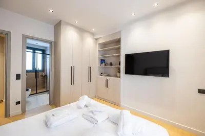 a white room with a bed and a television at Rooms151 Premium Suite in the Center of Athens 4th floor-8 in Athens