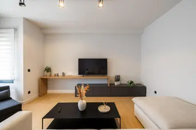 a living room with a couch and a tv at Rooms151 Premium Suite in the Center of Athens 4th floor-8 in Athens
