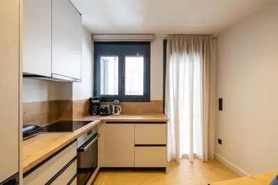 a kitchen with white cabinets and a window at Rooms151 Premium Suite in the Center of Athens 4th floor-8 in Athens