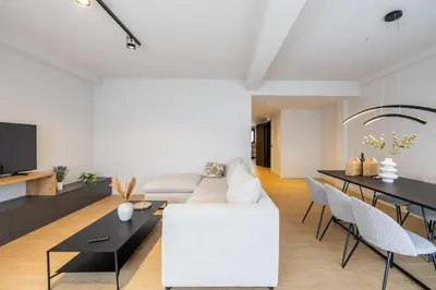 a living room with a white couch and a table at Rooms151 Premium Suite in the Center of Athens 4th floor-8 in Athens