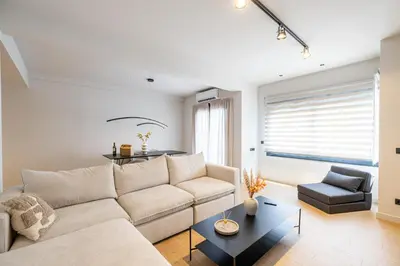 a living room with a couch and a table at Rooms151 Premium Suite in the Center of Athens 4th floor-8 in Athens