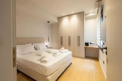 a bedroom with a white bed with towels on it at Rooms151 Premium Suite in the Center of Athens 4th floor-8 in Athens