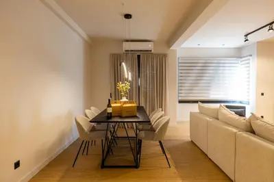 a living room with a dining room table and a couch at Rooms151 Premium Suite in the Center of Athens 4th floor-8 in Athens