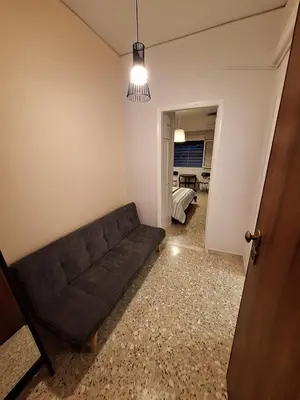 a living room with a couch and a bedroom at Central Modern Stay Apartment-5min walk from metro in Athens