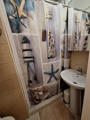 a bathroom with a sink and a shower curtain at Central Modern Stay Apartment-5min walk from metro in Athens