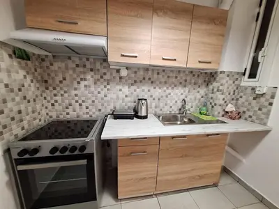 a small kitchen with a stove and a sink at Central Modern Stay Apartment-5min walk from metro in Athens