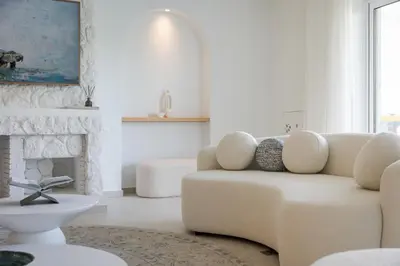 a living room with a couch and a fireplace at Arche Residence Glyfada in Athens