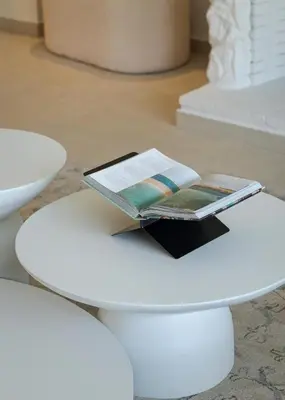 a book sitting on top of a white table at Arche Residence Glyfada in Athens