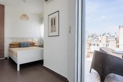 a bedroom with a bed and a view of a city at Town house by Phoenix Apartments in Athens