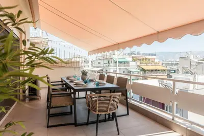 a balcony with a table and chairs and a view at Town house by Phoenix Apartments in Athens