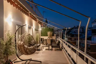 a balcony with chairs and a swing at Town house by Phoenix Apartments in Athens