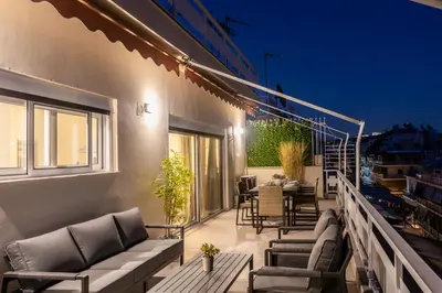 a balcony with chairs and a table on a building at Town house by Phoenix Apartments in Athens