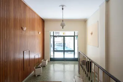 a hallway with a staircase and a door to a car at RoomsByRamez -Chill Bright Stay- -Central Athens- in Athens
