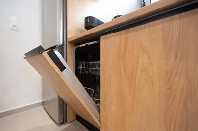 a dishwasher in a cabinet in a kitchen at RoomsByRamez -Chill Bright Stay- -Central Athens- in Athens