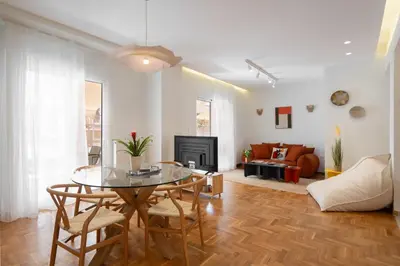 a living room with a table and a couch at RoomsByRamez -Chill Bright Stay- -Central Athens- in Athens
