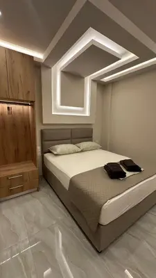 a bedroom with a large bed with a ceiling at Lush Studio Apartment in Athens