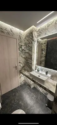 a stone bathroom with a sink and a toilet at Lush Studio Apartment in Athens