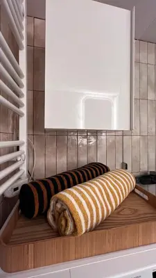 two towels on a wooden shelf in a kitchen at Acropolis Sunset Paradise in Athens