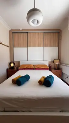 a bedroom with a large bed with three pillows on it at Acropolis Sunset Paradise in Athens