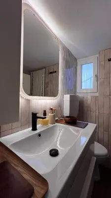a bathroom with a large white sink with a mirror at Acropolis Sunset Paradise in Athens