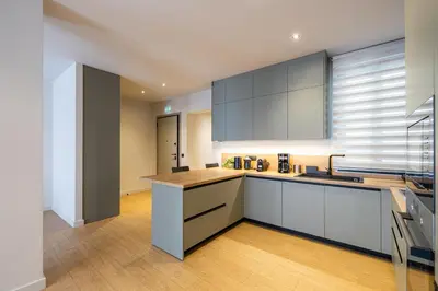 a kitchen with white cabinets and a wooden floor at Rooms151 Premium Suite in the Heart of Athens 4th floor-9 in Athens
