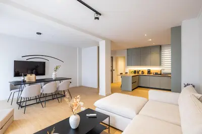 a living room with a white couch and a table at Rooms151 Premium Suite in the Heart of Athens 4th floor-9 in Athens