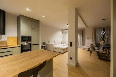 a kitchen and living room with a table in a room at Rooms151 Premium Suite in the Heart of Athens 4th floor-9 in Athens