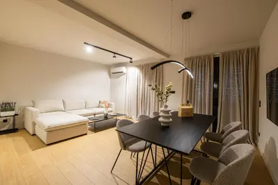 a living room with a couch and a table and chairs at Rooms151 Premium Suite in the Heart of Athens 4th floor-9 in Athens