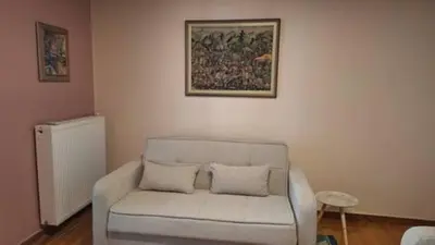 a living room with a couch and a picture on the wall at Solonos Amber Muse in Athens