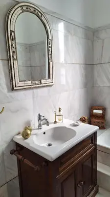 a bathroom with a sink and a mirror at Solonos Amber Muse in Athens