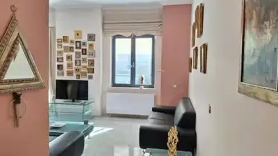 a living room with a couch and a television at Solonos Amber Muse in Athens