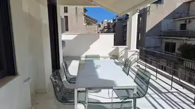 a table and chairs on the balcony of a building at Solonos Amber Muse in Athens
