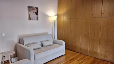 a living room with a couch and a cabinet at Solonos Amber Muse in Athens