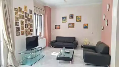 a living room with two couches and a television at Solonos Amber Muse in Athens
