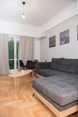 a living room with a couch and a table at The Athenian Chic in Athens