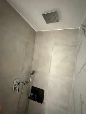 a bathroom with a shower with a shower head at The Athenian Chic in Athens
