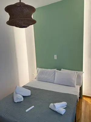 a bed with two towels on top of it at The Athenian Chic in Athens