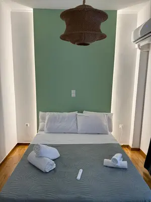 a bed with two towels and two pillows on it at The Athenian Chic in Athens