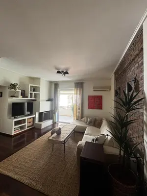 a living room with a couch and a brick wall at Central Athens Unique Apartment in Athens