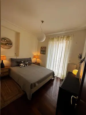 a bedroom with a bed and a large window at Central Athens Unique Apartment in Athens