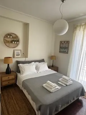 a bedroom with a bed with two towels on it at Central Athens Unique Apartment in Athens