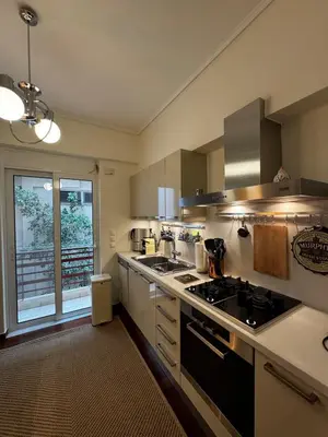 a large kitchen with a stove and a window at Central Athens Unique Apartment in Athens