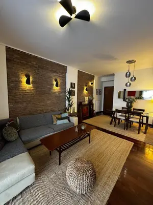 a living room with a couch and a ceiling fan at Central Athens Unique Apartment in Athens
