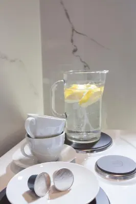 a table with a glass of water and a cup at Cozy Apartment Next To PIRAEUS PORT in Piraeus