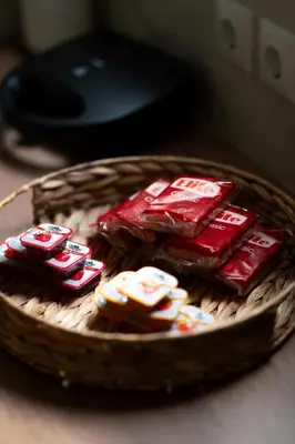a basket filled with packets of cocacolavelt at Modern Rooms Pagrati in Athens