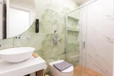 a bathroom with a sink and a shower at Modern Rooms Pagrati in Athens