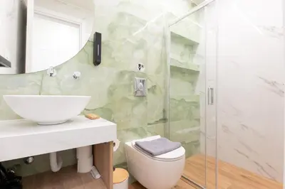 a bathroom with a sink and a shower at Modern Rooms Pagrati in Athens