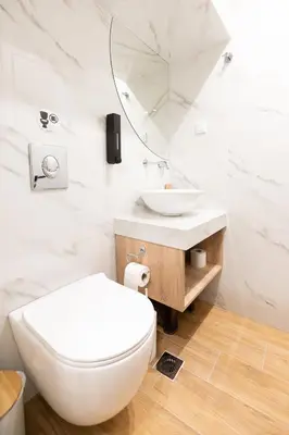 a white bathroom with a toilet and a sink at Modern Rooms Pagrati in Athens