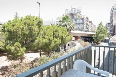 a balcony with a bench and trees and buildings at Minimal Flat in Historic Kerameikos by ΜΡS in Athens