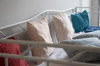 a group of pillows sitting on a bed at Minimal Flat in Historic Kerameikos by ΜΡS in Athens